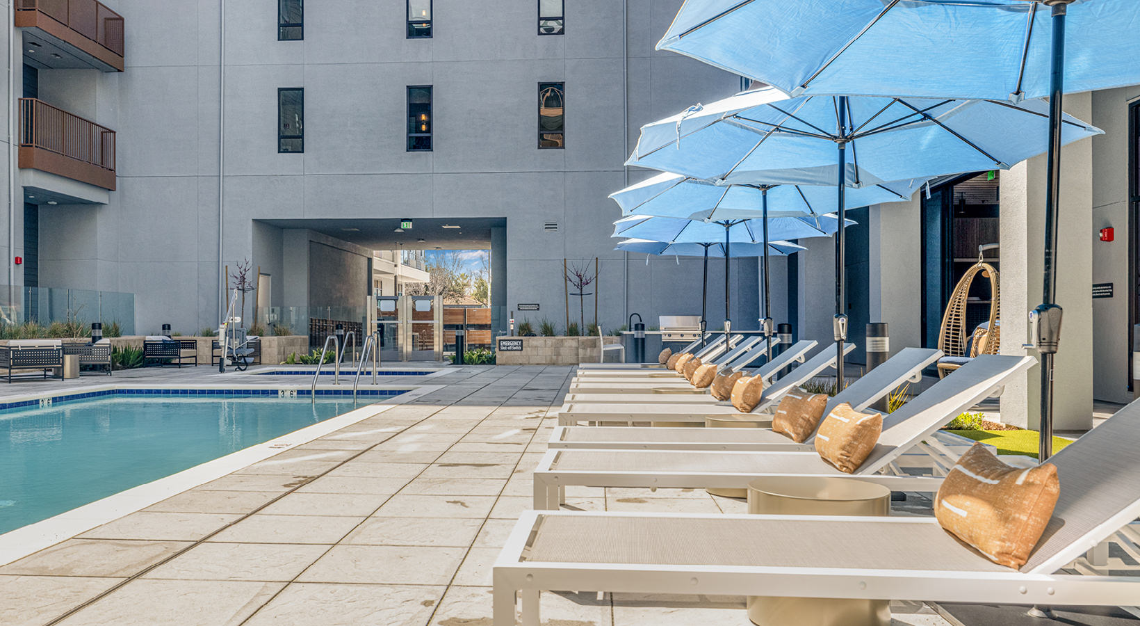 Resort-style swimming pool with lounge seating