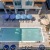 Resort-style swimming pool with lounge seating